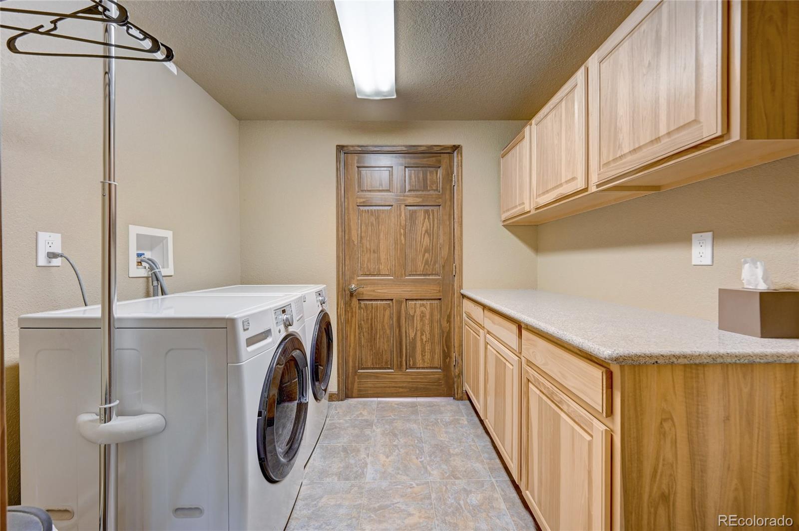 411 Spring Drive Pine, CO 80470 - Photo 29 of 40 a view of hallway with washer and dryer