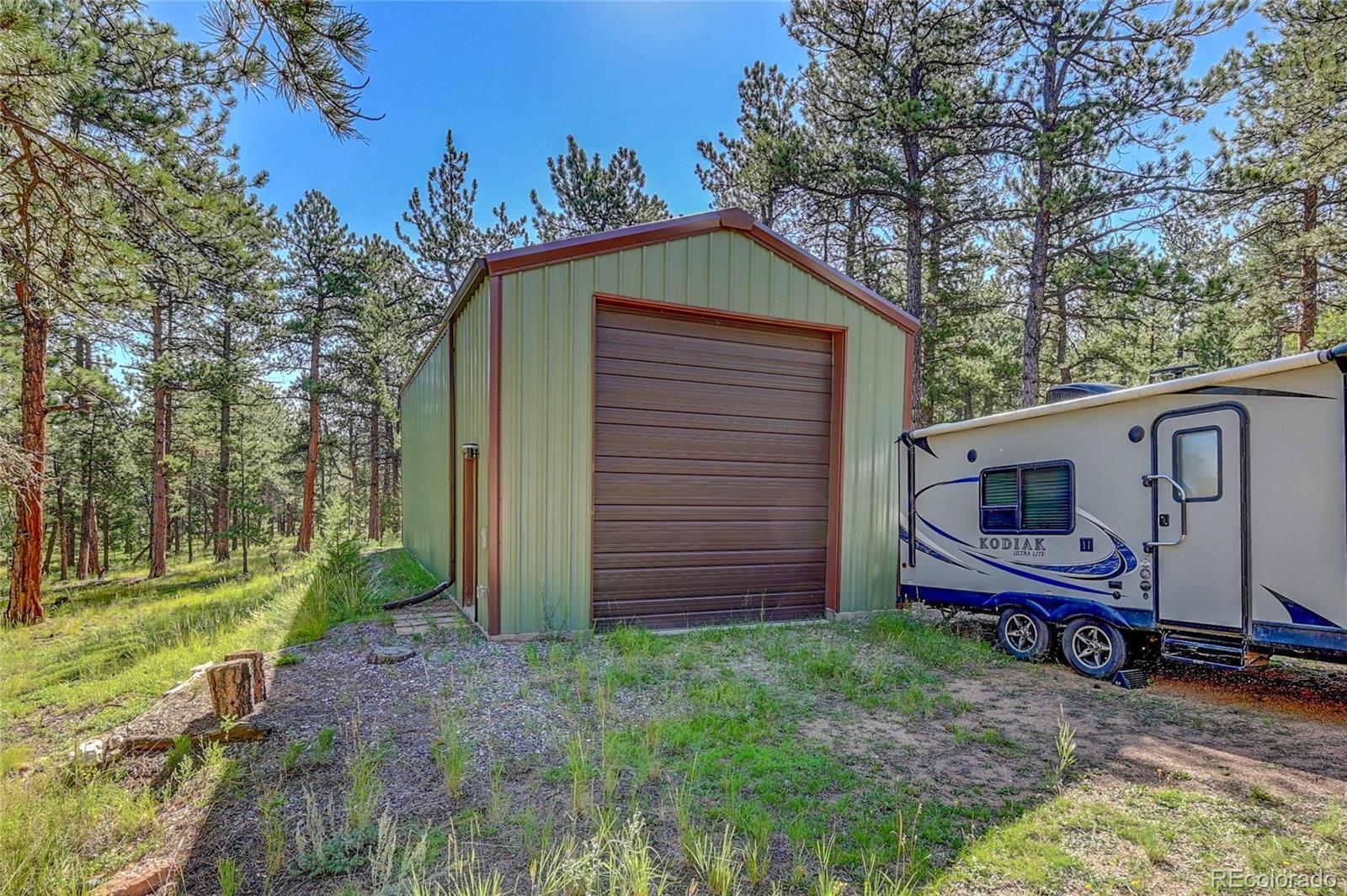 411 Spring Drive Pine, CO 80470 - Photo 7 of 40 a view of a house with a yard
