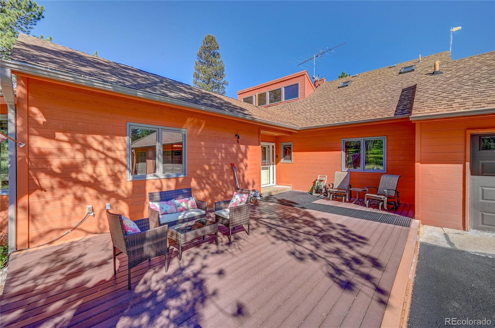 411 Spring Drive Pine, CO 80470 - Photo 9 of 40 a front view of a house with sitting area