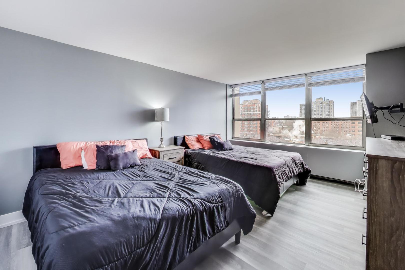 655 West Irving Park Road, Unit 814 Chicago, IL 60613 - Photo 12 of 34 a bedroom with a bed and a window