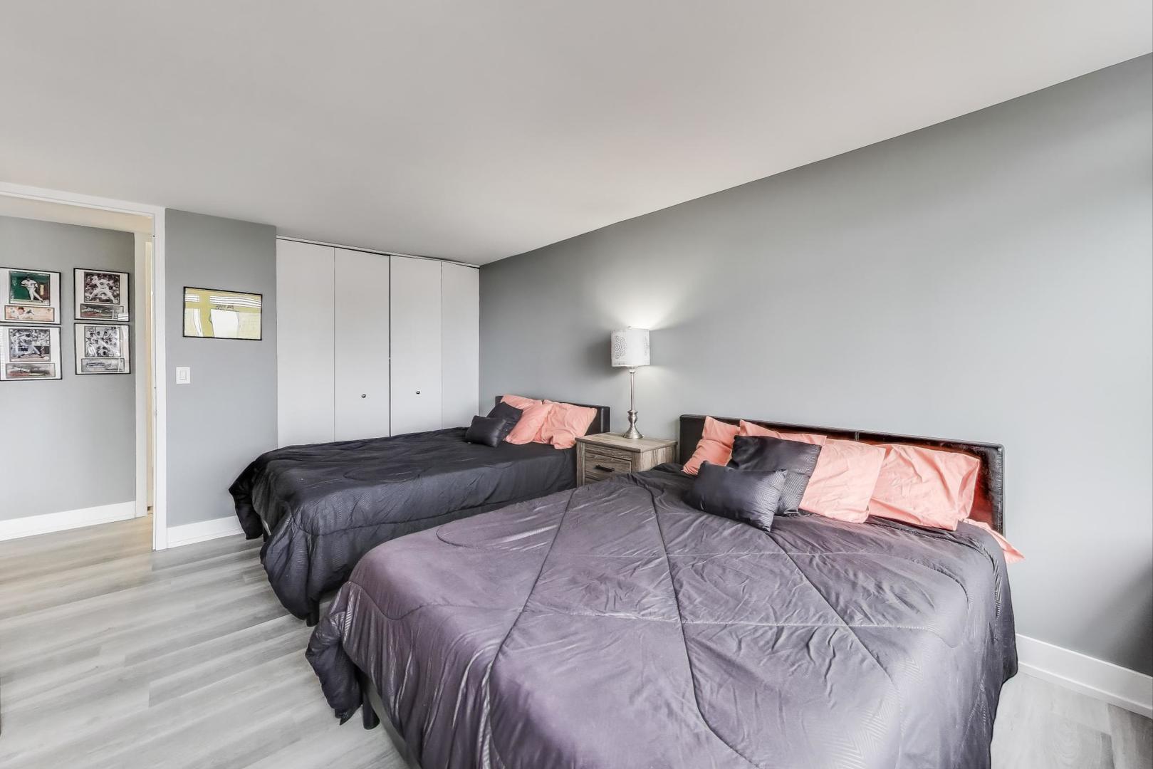 655 West Irving Park Road, Unit 814 Chicago, IL 60613 - Photo 14 of 34 a bedroom with a bed and wooden floor