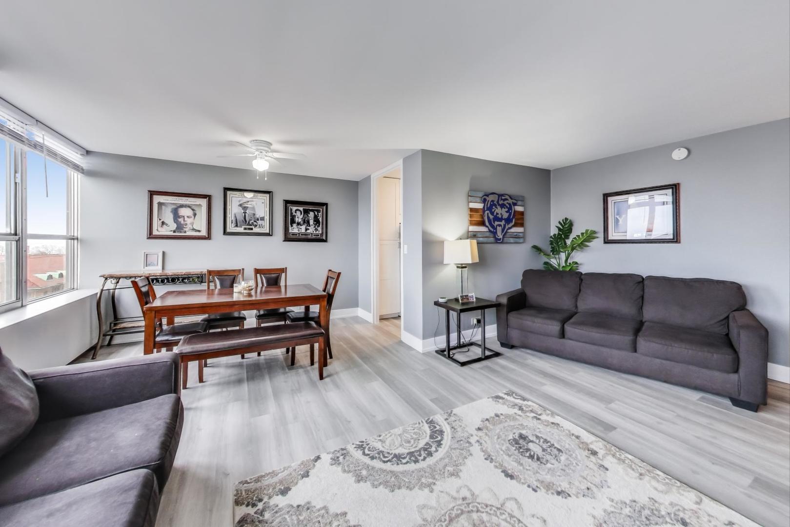 655 West Irving Park Road, Unit 814 Chicago, IL 60613 - Photo 7 of 34 a living room with furniture and a wooden floor