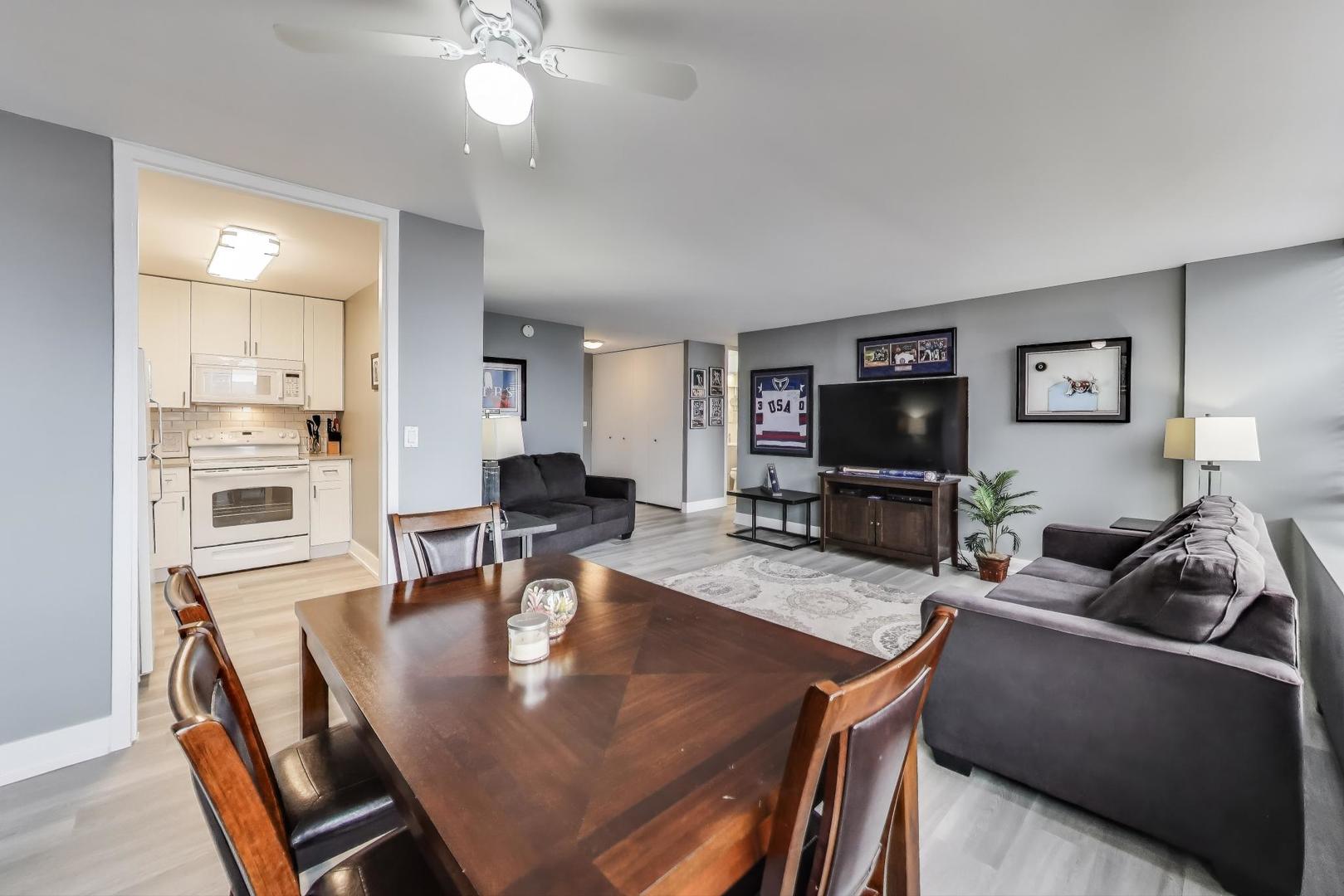 655 West Irving Park Road, Unit 814 Chicago, IL 60613 - Photo 9 of 34 a living room with stainless steel appliances kitchen island granite countertop furniture and a kitchen view