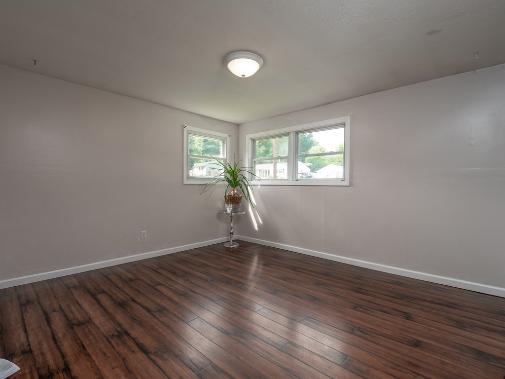 71 Treetop Avenue Springfield, MA 01118 - Photo 18 of 23 an empty room with wooden floor and windows
