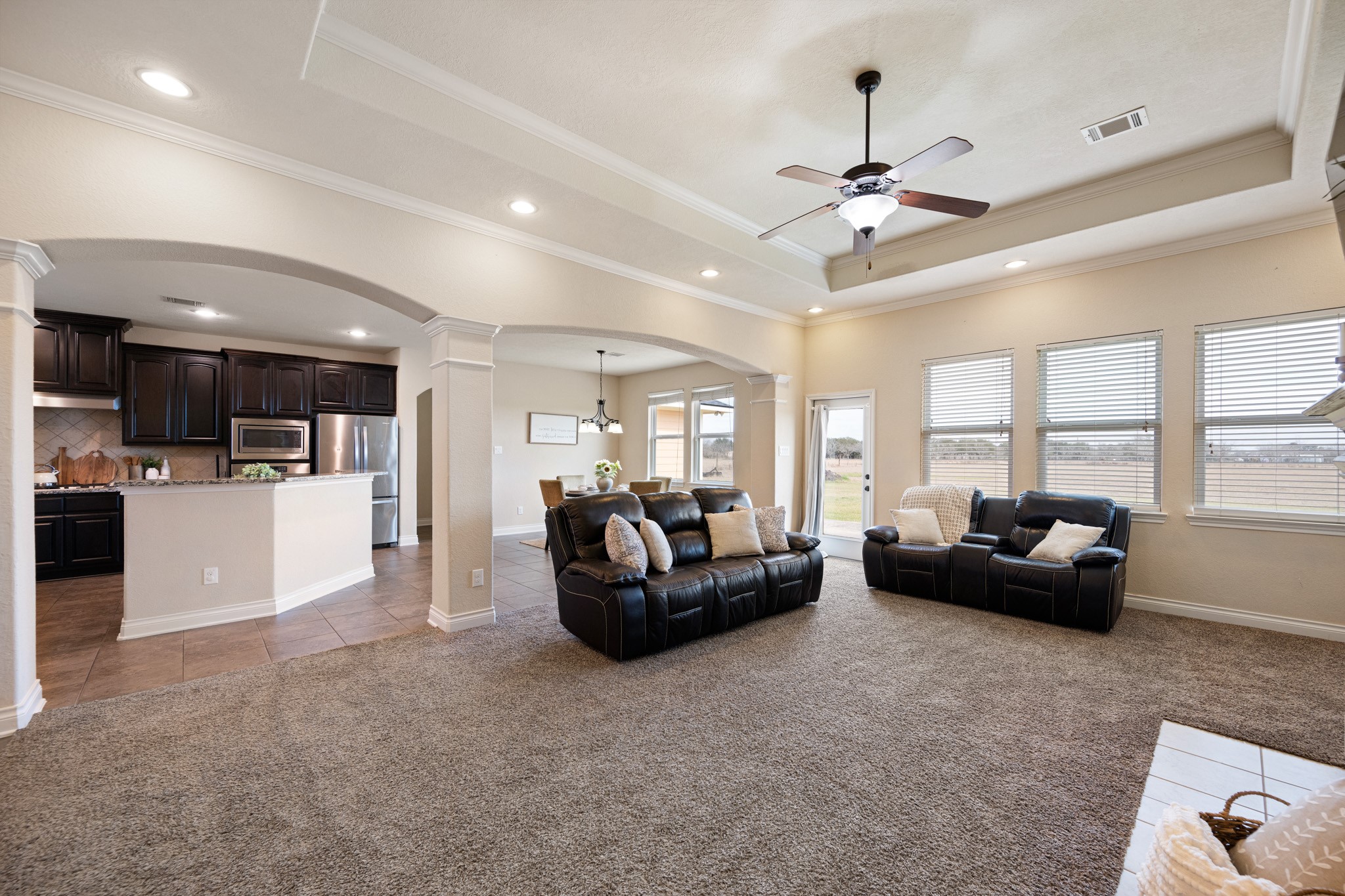 8131 Brinkmeyer Road Needville, TX 77461 - Photo 11 of 34 Living room seamlessly connects to a stylish kitchen.