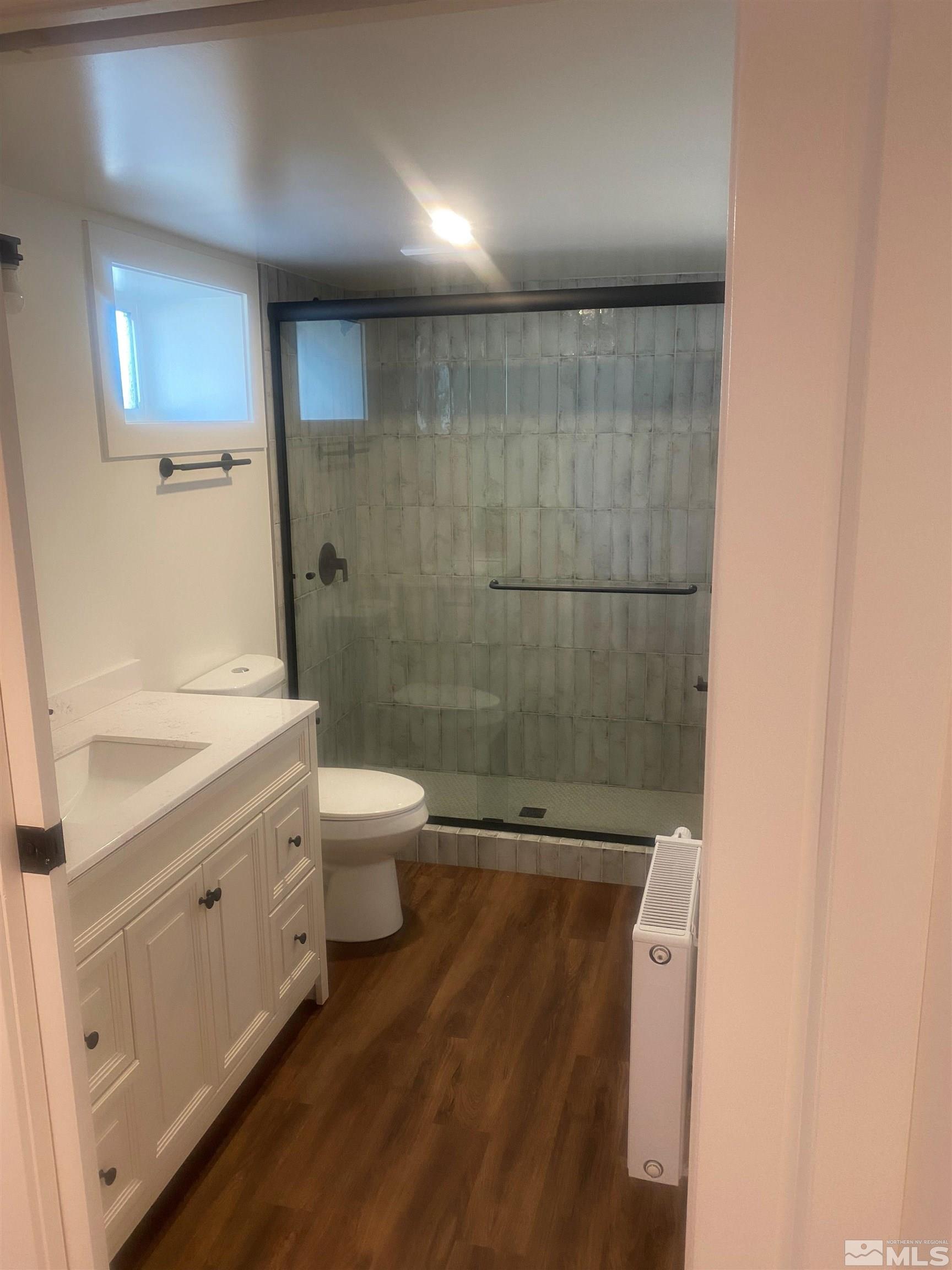 780 Forest Street Reno, NV 89509 - Photo 10 of 16 a bathroom with a granite countertop shower toilet and a sink