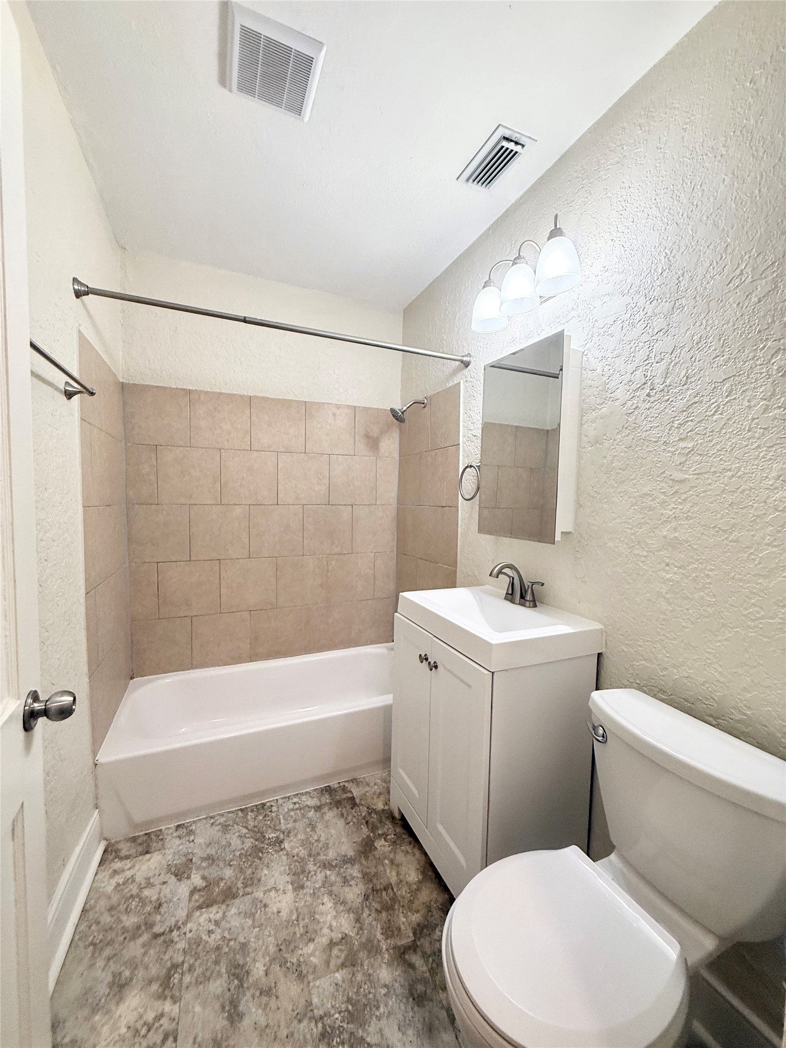 1232 San Felipe Street Angleton, TX 77515 - Photo 10 of 16 a bathroom with a sink a toilet and bathtub