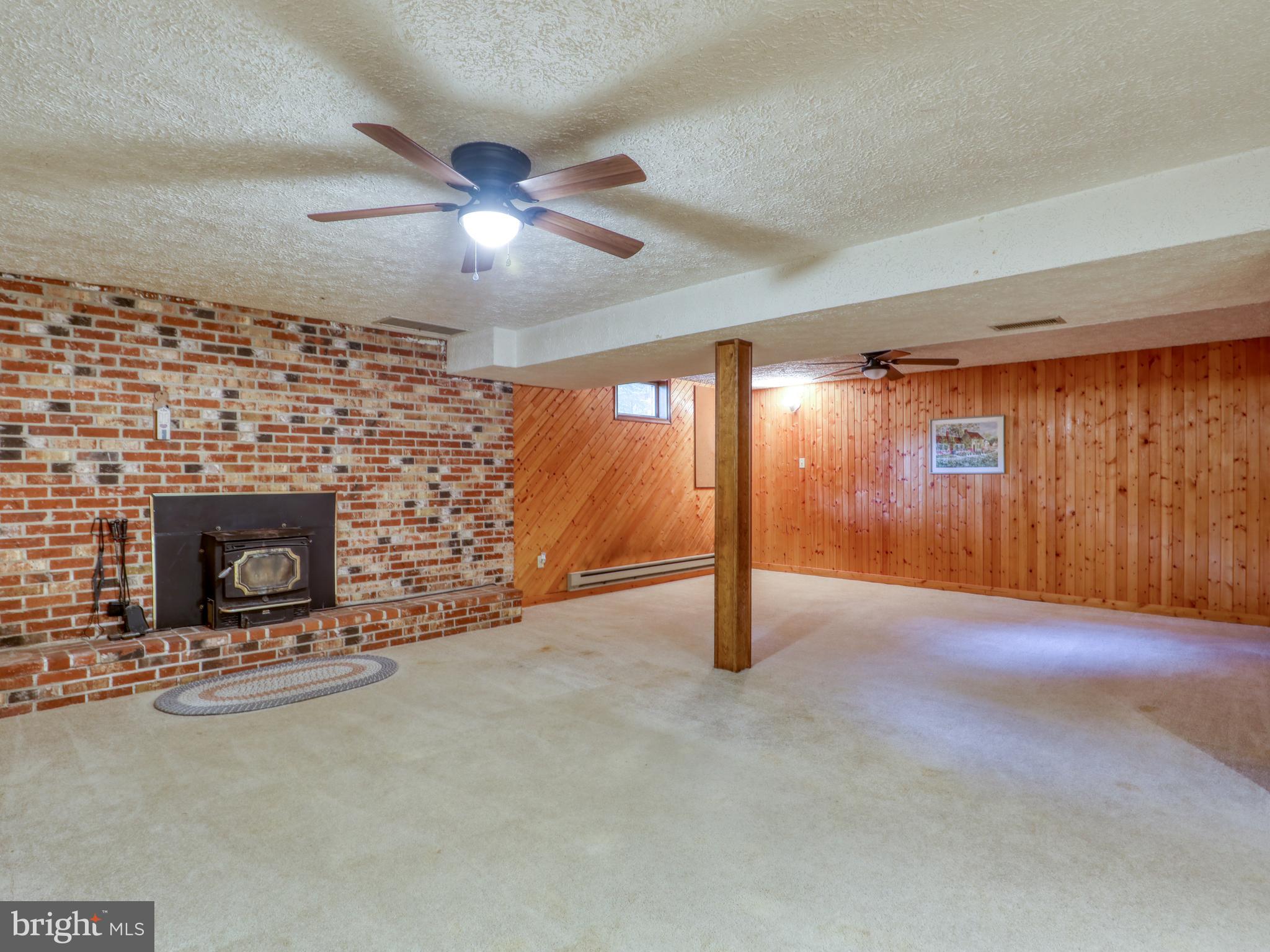 104 Forest Ridge Road Winchester, VA 22602 - Photo 29 of 46 Rec Room with brick surround pellet stove