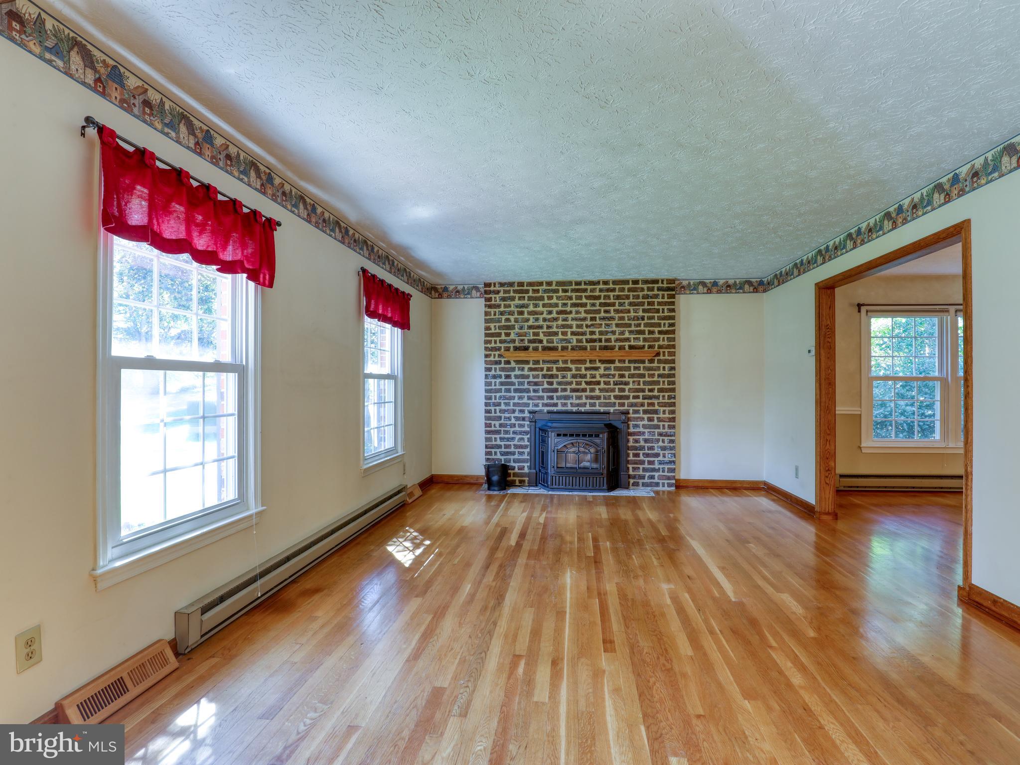 104 Forest Ridge Road Winchester, VA 22602 - Photo 3 of 46 Living room with pellet stove and brick surround