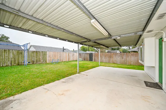 a view of a backyard with wooden fence