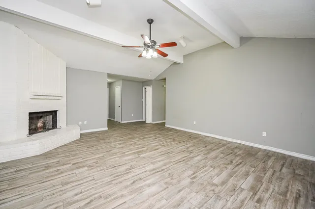 wooden floor in an empty room with a fireplace