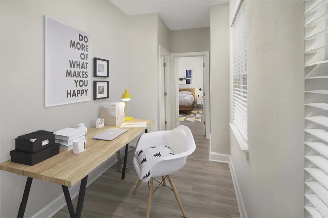 a view of a workspace room with furniture and wooden floor