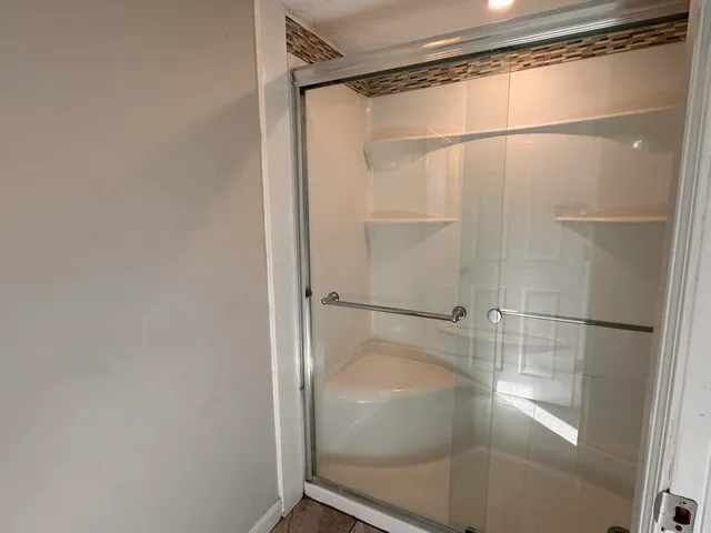 a bathroom with a glass shower door