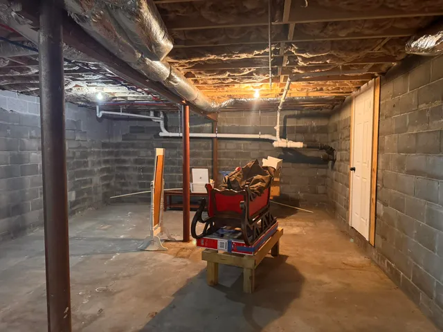 a view of a room with wooden chairs