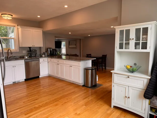 a kitchen with stainless steel appliances kitchen island granite countertop a sink and cabinets