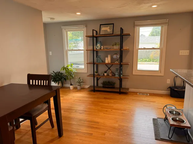 a view of a livingroom with furniture window and wooden floor