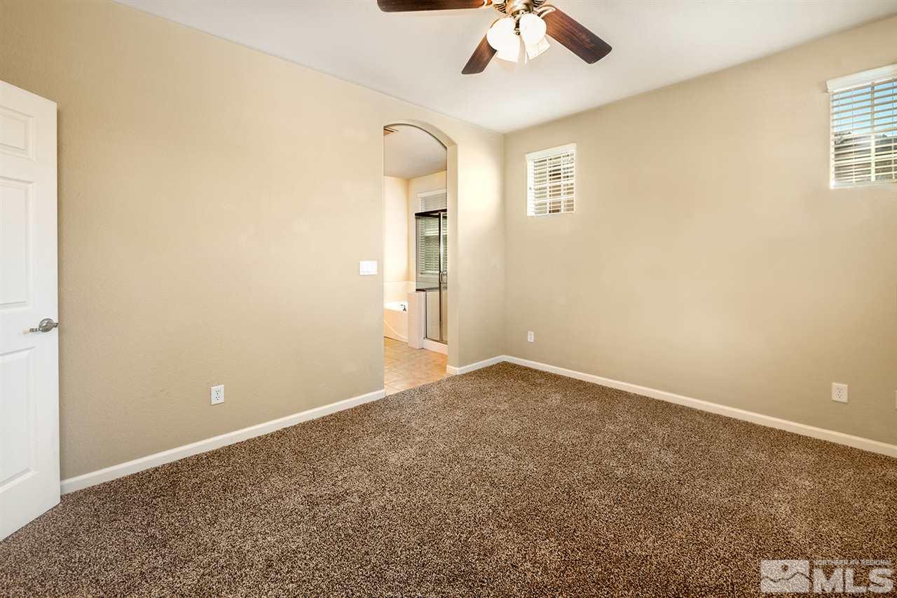 1875 Wind Ranch Road, Unit C Reno, NV 89521 - Photo 9 of 16 an empty room with a empty space and a ceiling fan