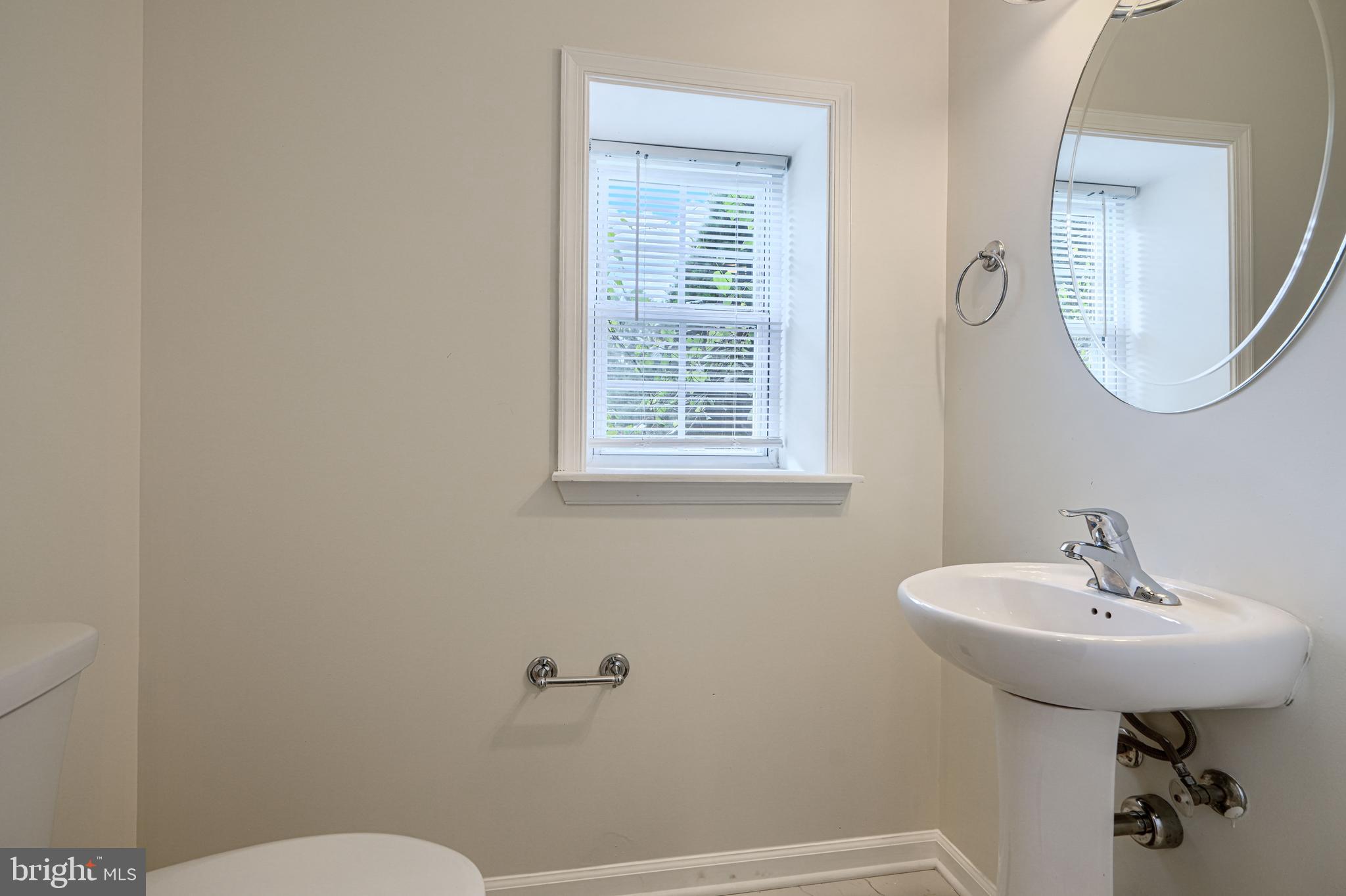 605 Paradise Road Aberdeen, MD 21001 - Photo 19 of 47 a bathroom with a sink a mirror and a toilet