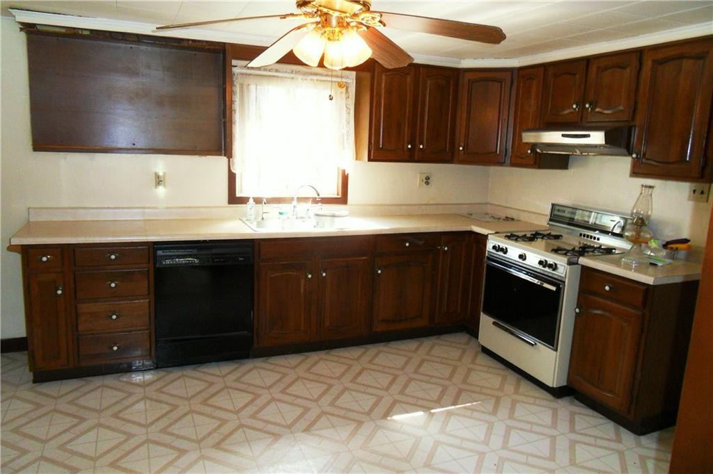 3722 North Balsiger Road Vandergrift, PA 15690 - Photo 11 of 18 a kitchen with stainless steel appliances granite countertop a stove a sink and a microwave