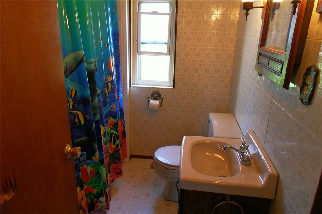 3722 North Balsiger Road Vandergrift, PA 15690 - Photo 15 of 18 a bathroom with a sink a toilet and shower curtain