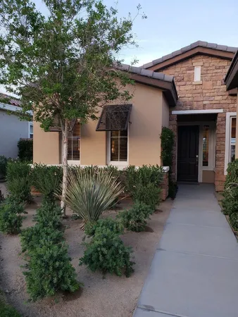 a front view of house with green space