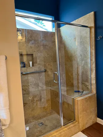 a bathroom with a glass shower door