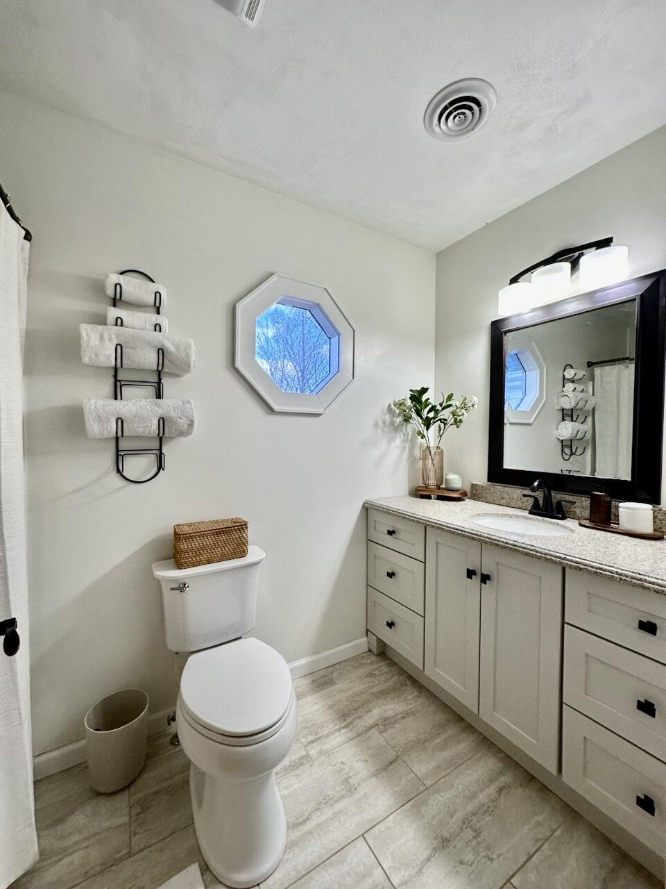 1818 Burnt Chimney Road Wirtz, VA 24184 - Photo 19 of 38 a spacious bathroom with a toilet a sink and a mirror