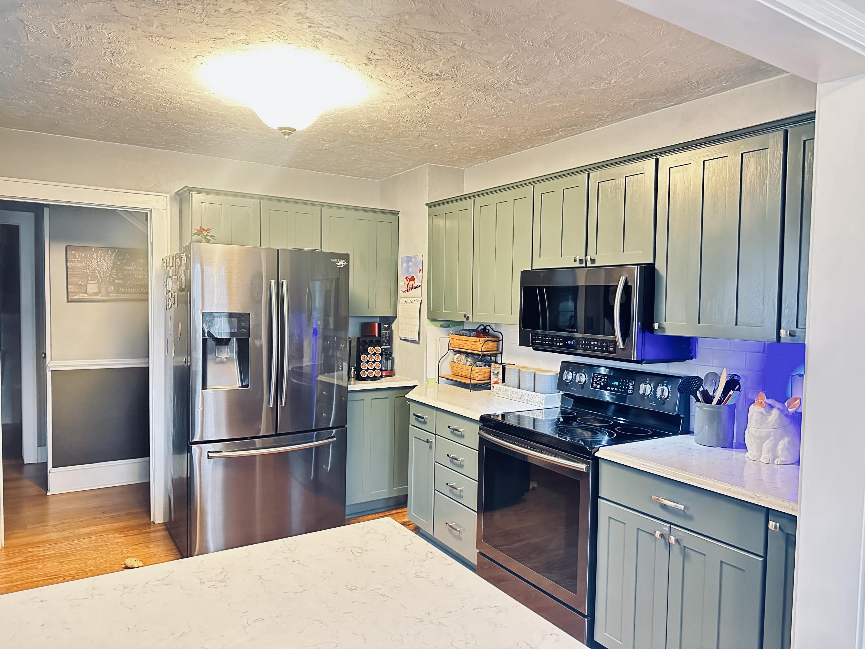 1818 Burnt Chimney Road Wirtz, VA 24184 - Photo 5 of 38 a kitchen with stainless steel appliances a stove a refrigerator and a sink
