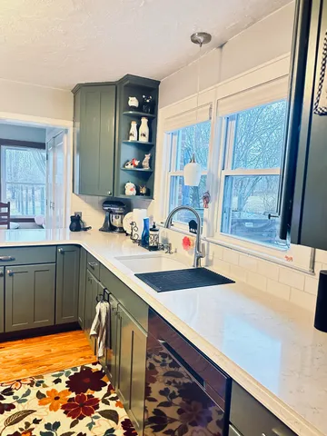 a view of a house with a small yard and plants