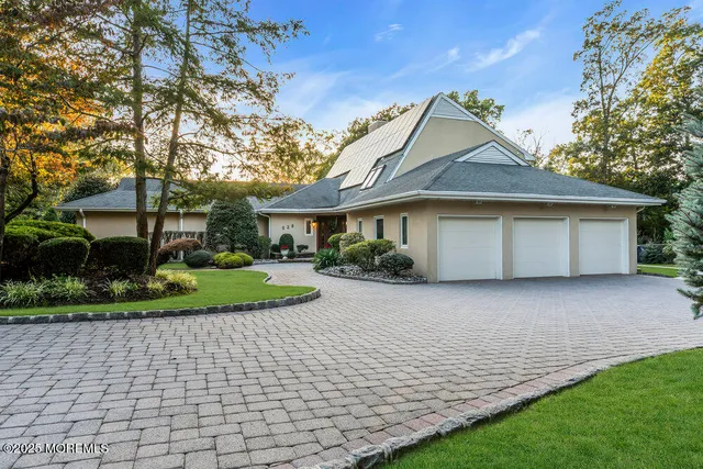 a view of a house with potted plants and a bench