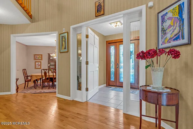 a bedroom with a large bed and a chandelier