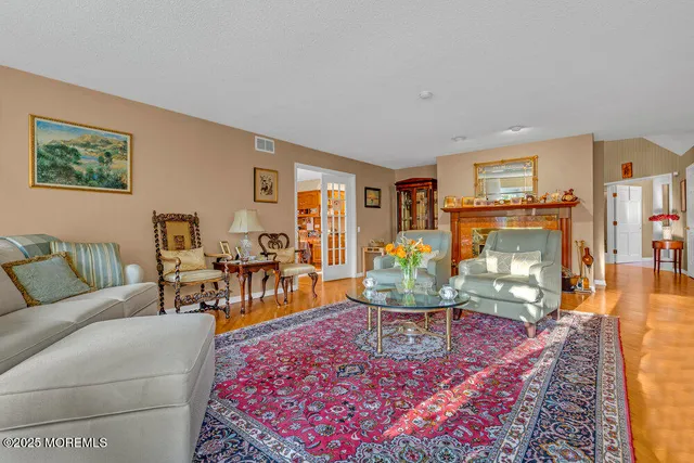 an aerial view of a city with lots of residential buildings ocean and mountain view in back