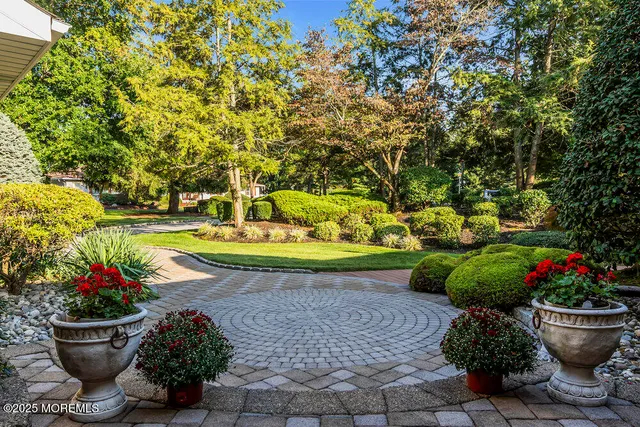 a patio with wooden floor a yard a table and chairs