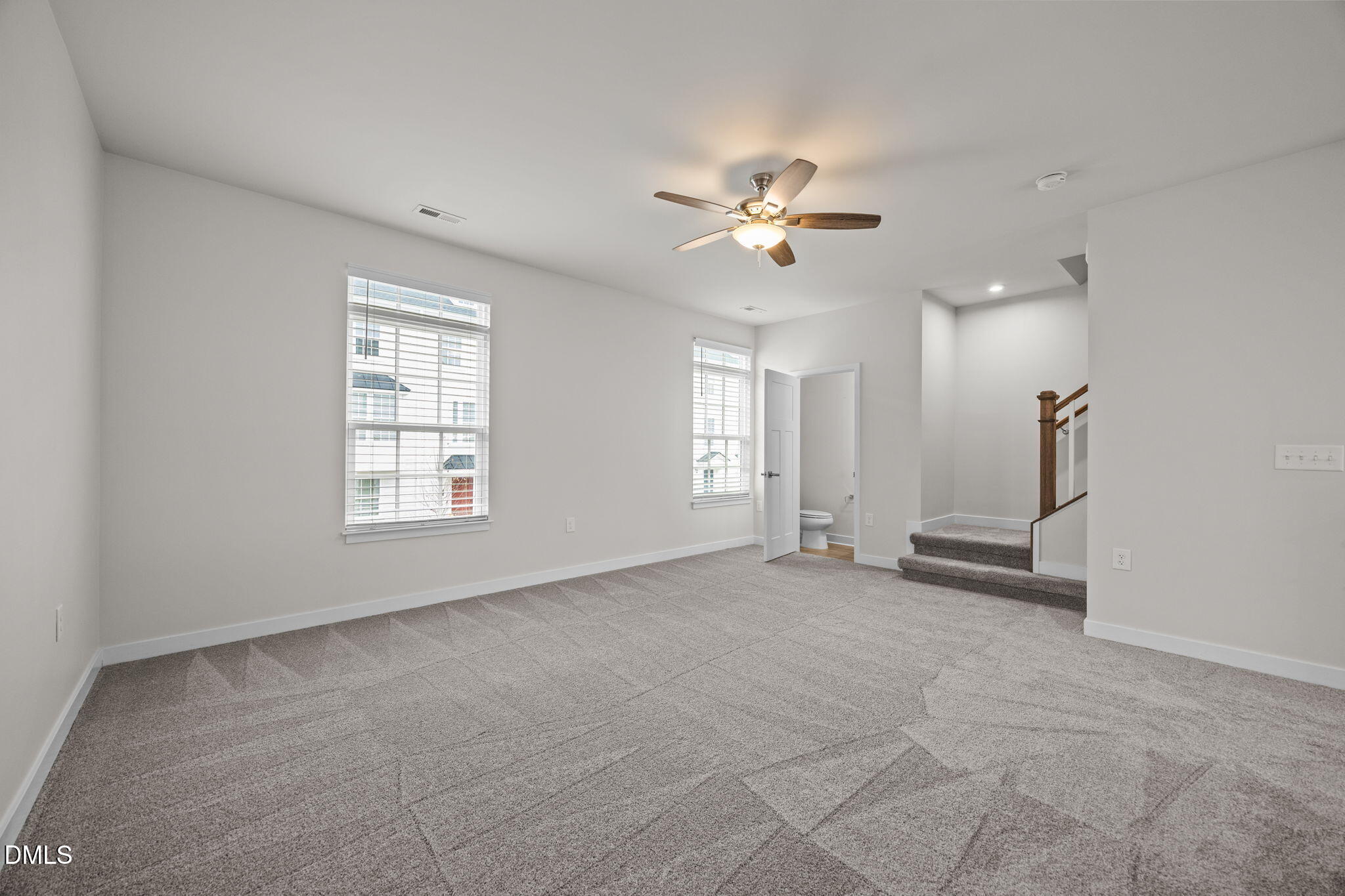 945 Anthem Lane Durham, NC 27713 - Photo 15 of 51 an empty room with windows and ceiling fan