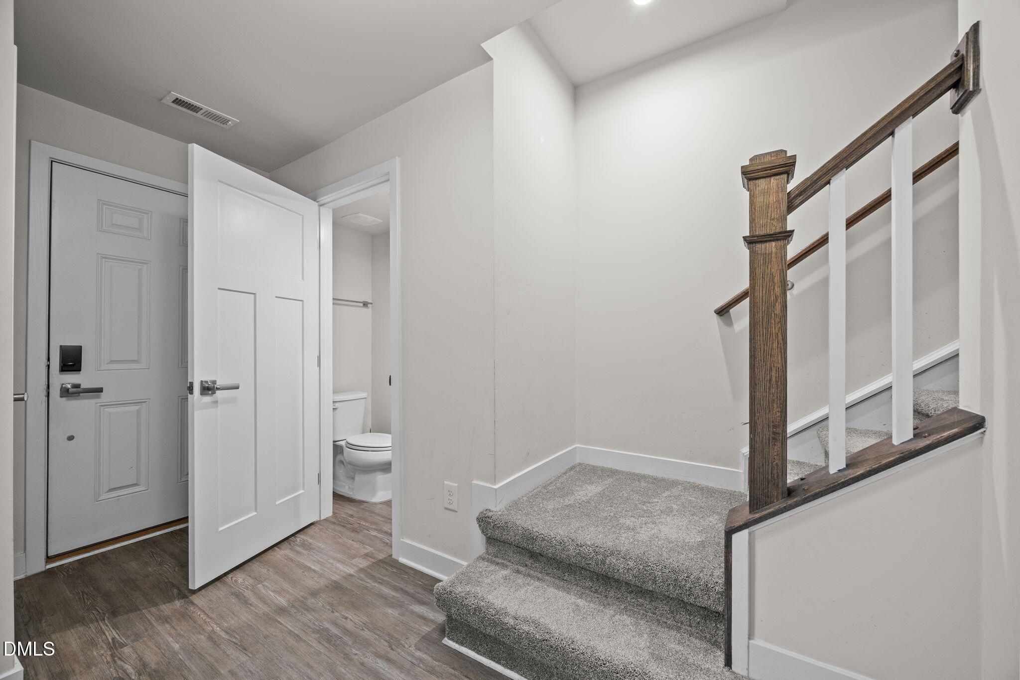 945 Anthem Lane Durham, NC 27713 - Photo 20 of 51 a view of room with stairs and wooden floor