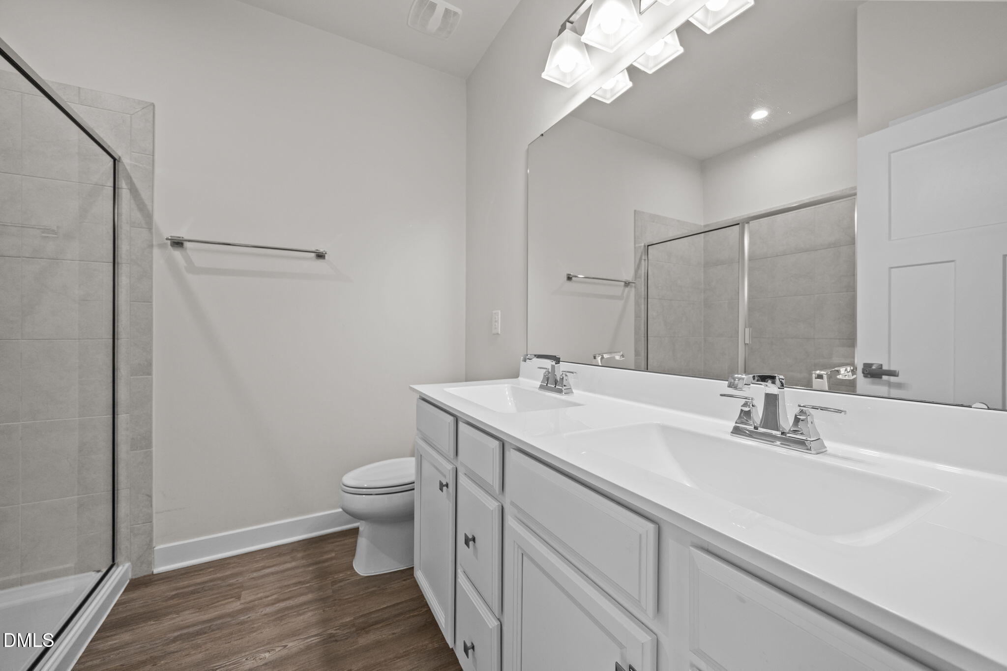 945 Anthem Lane Durham, NC 27713 - Photo 23 of 51 a bathroom with a sink a toilet a light fixture and a mirror