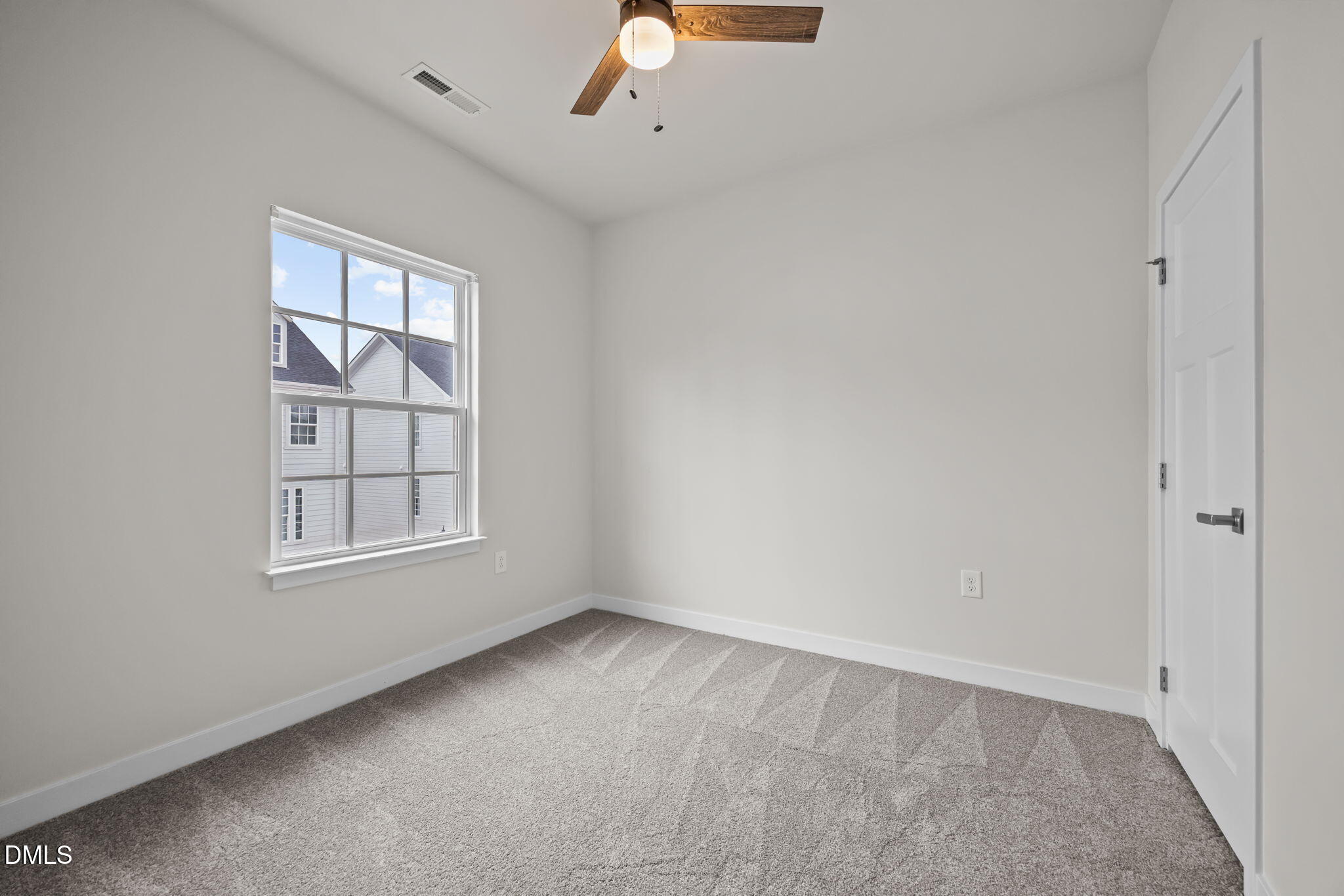 945 Anthem Lane Durham, NC 27713 - Photo 26 of 51 an empty room with chandelier fan and window