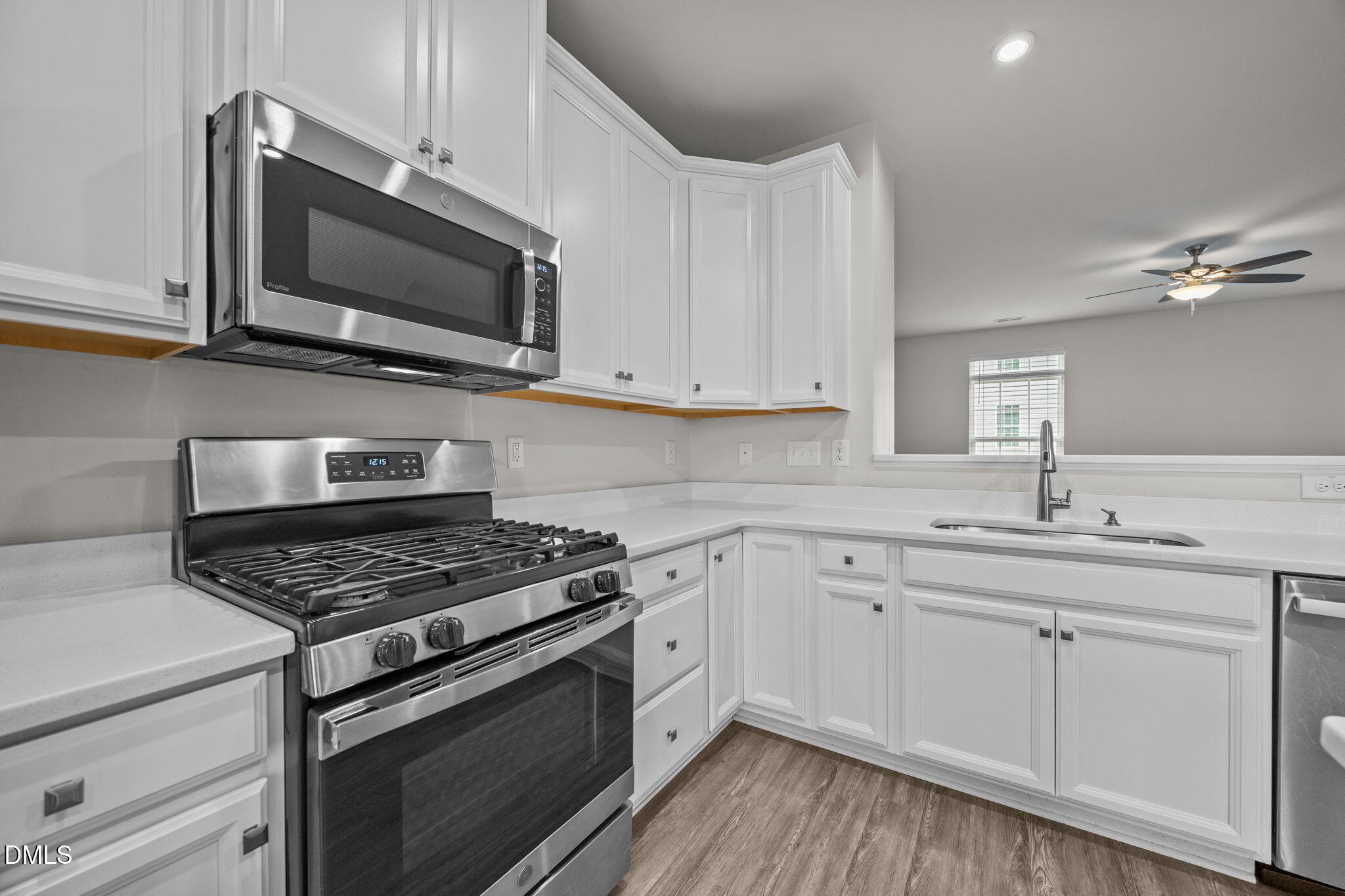 945 Anthem Lane Durham, NC 27713 - Photo 7 of 51 a kitchen with stainless steel appliances white cabinets granite counter tops and a window