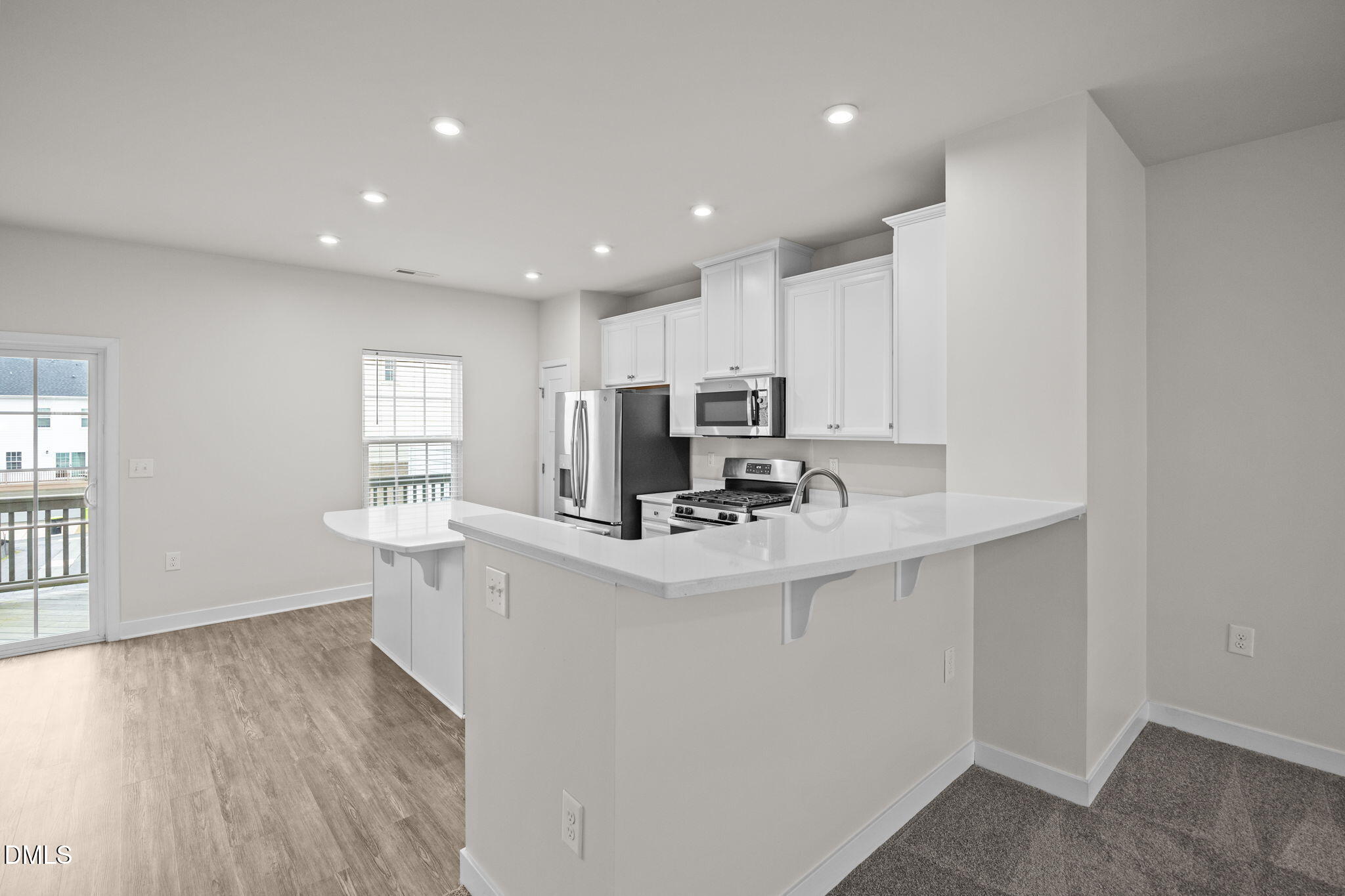 945 Anthem Lane Durham, NC 27713 - Photo 9 of 51 a view of kitchen with stainless steel appliances granite countertop a sink a stove a refrigerator a center island and couches