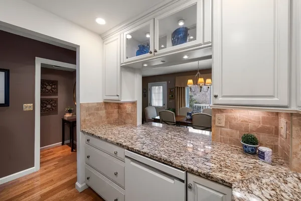 a kitchen with granite countertop a sink and cabinets