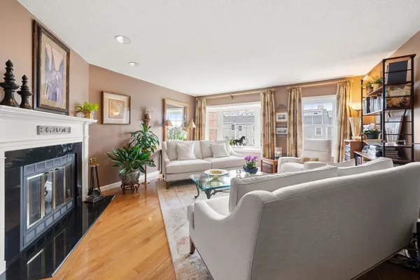 a living room with furniture large window and a fireplace