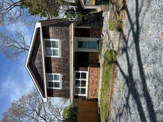 106 Lewis Road East Quogue, NY 11942 - Photo 1 of 12 a front view of a house with a yard