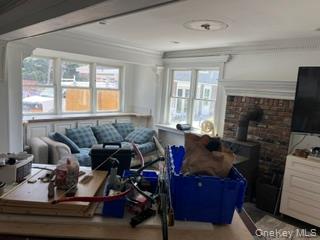 106 Lewis Road East Quogue, NY 11942 - Photo 2 of 12 a living room with furniture and a flat screen tv