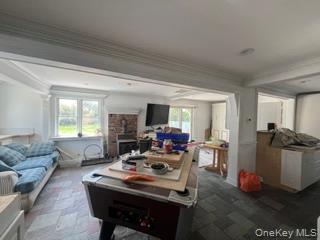 106 Lewis Road East Quogue, NY 11942 - Photo 4 of 12 a living room with furniture and a flat screen tv
