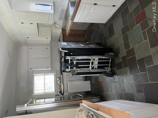 106 Lewis Road East Quogue, NY 11942 - Photo 5 of 12 a kitchen with a sink a stove and refrigerator