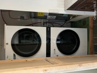 106 Lewis Road East Quogue, NY 11942 - Photo 6 of 12 a utility room with dryer and washer