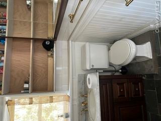 106 Lewis Road East Quogue, NY 11942 - Photo 7 of 12 a bathroom with a toilet and a sink