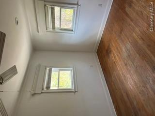 106 Lewis Road East Quogue, NY 11942 - Photo 8 of 12 an empty room with a window