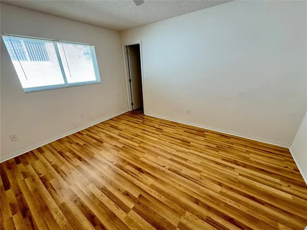 a view of a room with wooden floor and cabinet
