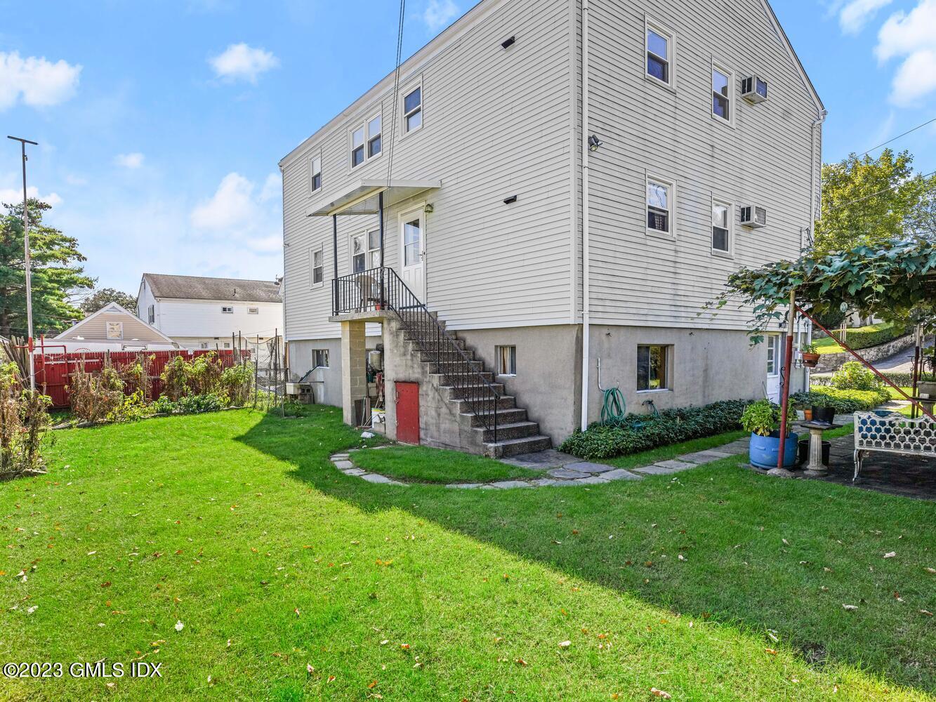 63 Cos Cob Avenue, Unit B Cos Cob, CT 06807 - Photo 12 of 14 a view of a house with backyard and garden